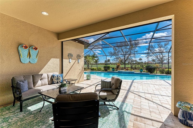 view of patio / terrace featuring a lanai, an outdoor pool, and an outdoor hangout area