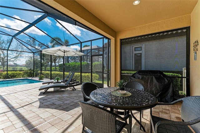 view of patio / terrace with glass enclosure and an outdoor pool