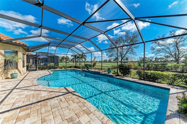 outdoor pool with a lanai and a patio