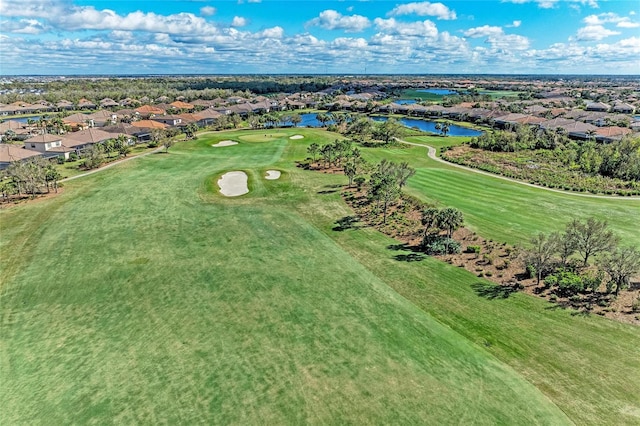 birds eye view of property with golf course view, a water view, and a residential view