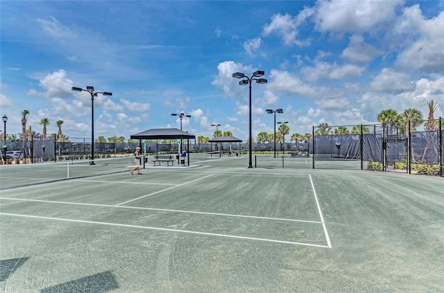 view of sport court with a gazebo and fence