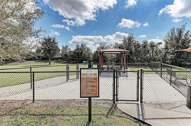 view of property's community featuring a gate, fence, and a gazebo