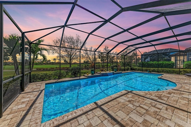 pool with glass enclosure and a patio