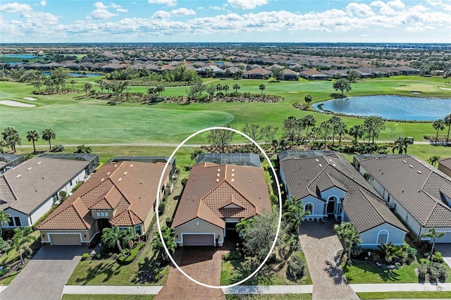 drone / aerial view with golf course view, a water view, and a residential view