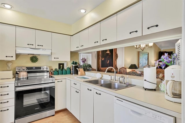 kitchen featuring stainless steel electric range oven, light countertops, a sink, dishwasher, and under cabinet range hood