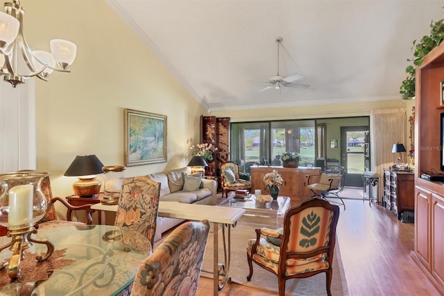 living area with plenty of natural light, ornamental molding, vaulted ceiling, and wood finished floors