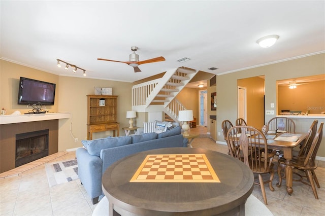 dining area featuring visible vents, stairway, a ceiling fan, and ornamental molding