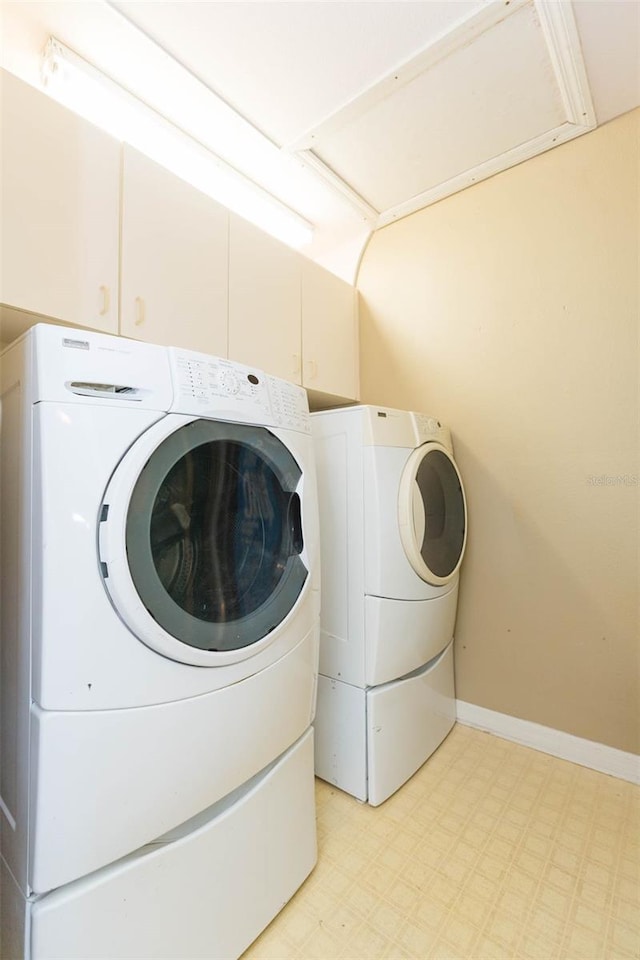 laundry room featuring laundry area, baseboards, separate washer and dryer, and light floors