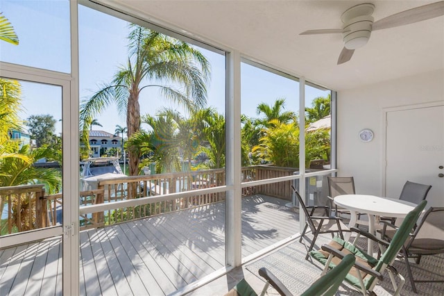 sunroom featuring a ceiling fan