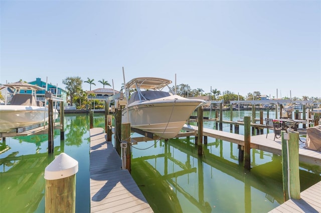 dock area with a water view and boat lift