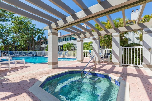 community pool featuring a patio area, a hot tub, fence, and a pergola