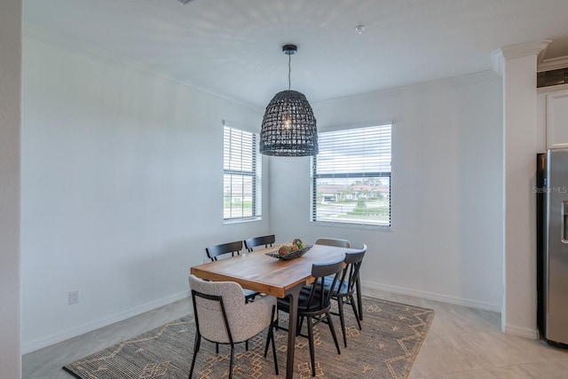 dining area featuring baseboards, light tile patterned floors, and crown molding