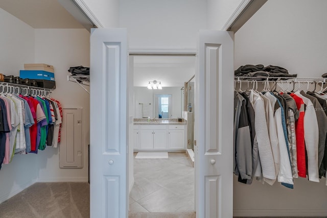 walk in closet featuring light colored carpet