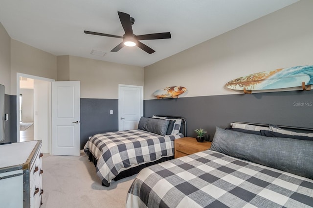 bedroom featuring a ceiling fan and light carpet