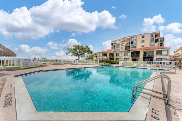 community pool featuring a patio area and fence