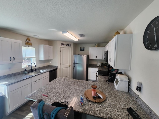 kitchen featuring white cabinetry, visible vents, appliances with stainless steel finishes, and a sink