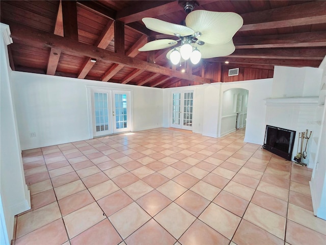 unfurnished living room featuring vaulted ceiling with beams, wooden ceiling, visible vents, a ceiling fan, and french doors