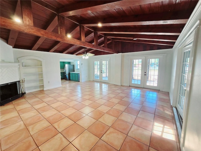 unfurnished living room featuring light tile patterned floors, built in shelves, wooden ceiling, a fireplace, and french doors