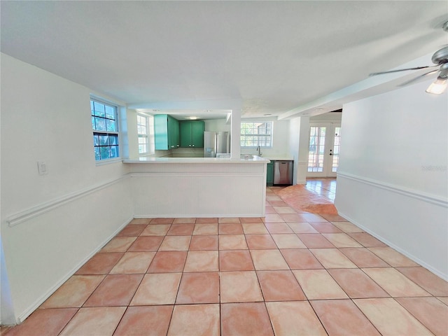 spare room featuring french doors, ceiling fan, and light tile patterned floors