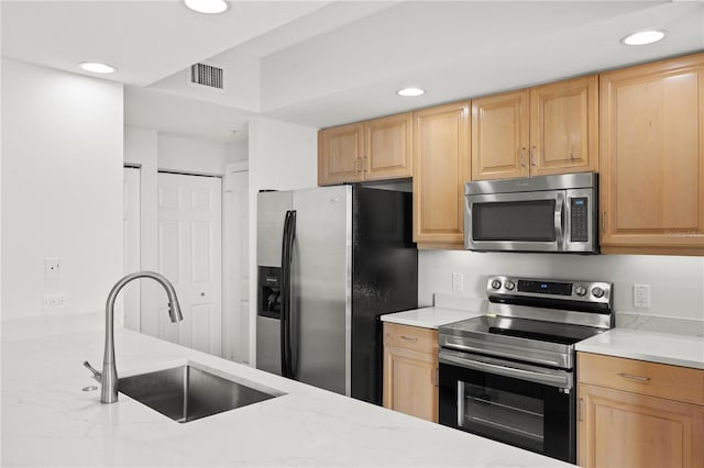 kitchen featuring appliances with stainless steel finishes, recessed lighting, visible vents, and a sink