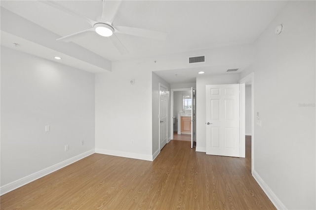 unfurnished room with baseboards, visible vents, ceiling fan, and wood finished floors