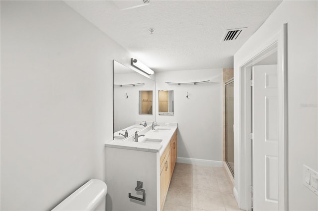 bathroom with a stall shower, visible vents, a sink, and double vanity