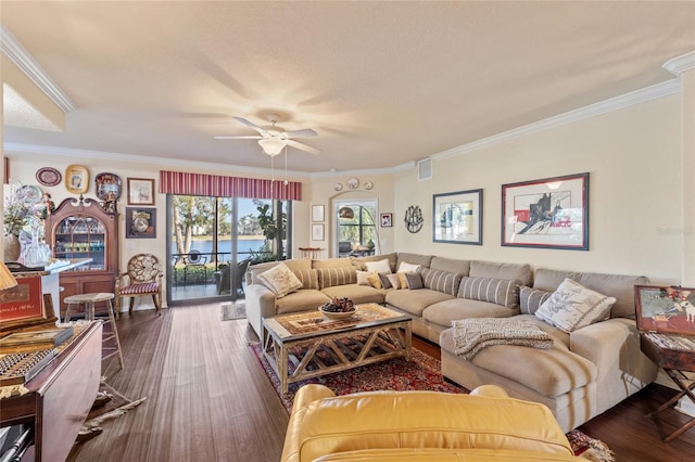 living room with a ceiling fan, dark wood-style flooring, visible vents, and crown molding