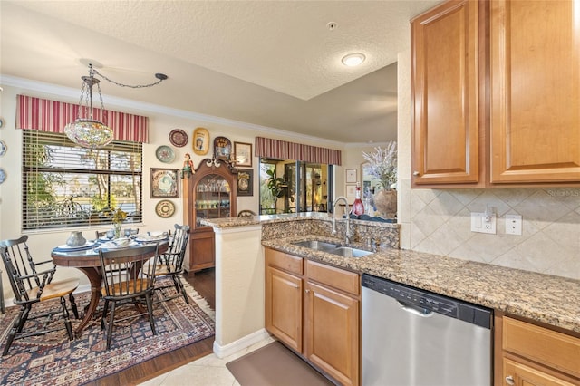 kitchen featuring decorative backsplash, dishwasher, ornamental molding, light stone countertops, and a sink