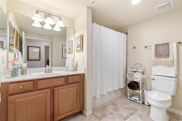 bathroom with visible vents, toilet, vanity, baseboards, and tile patterned floors