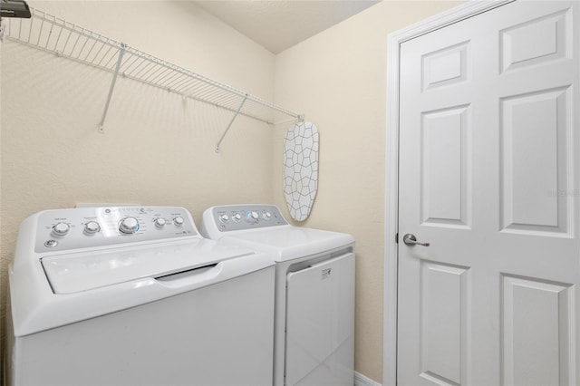 washroom featuring laundry area and washing machine and dryer