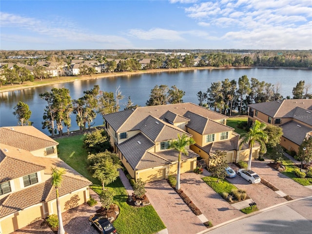 drone / aerial view with a residential view and a water view