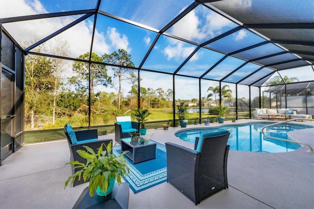 outdoor pool with a patio, a lanai, and an outdoor hangout area