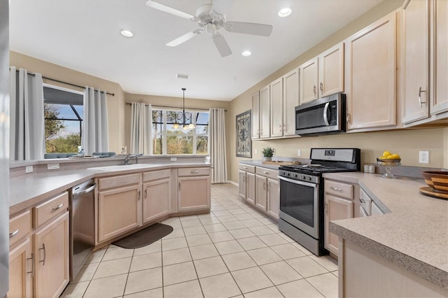 kitchen featuring a sink, plenty of natural light, appliances with stainless steel finishes, and light countertops