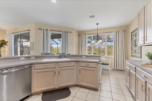 kitchen featuring a sink, stainless steel dishwasher, light tile patterned flooring, and light brown cabinetry