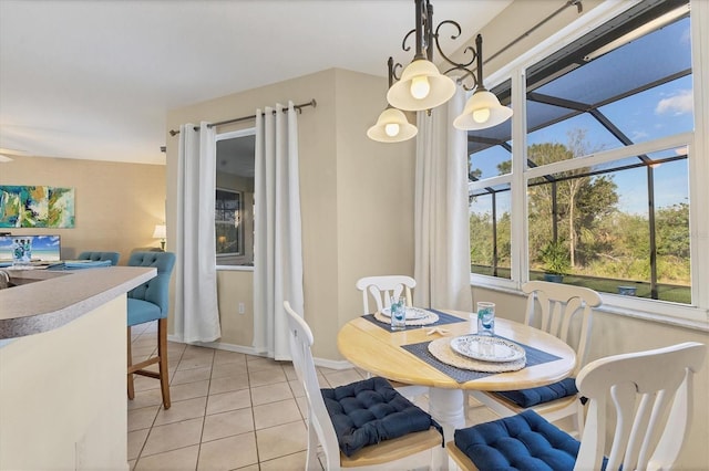 dining space featuring light tile patterned flooring and baseboards