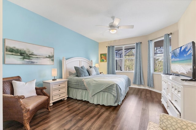 bedroom featuring baseboards, ceiling fan, and dark wood-style flooring