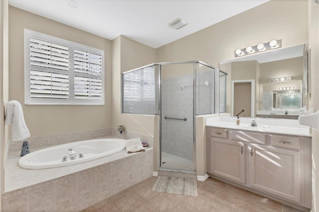 bathroom with vanity, a garden tub, a stall shower, and tile patterned floors