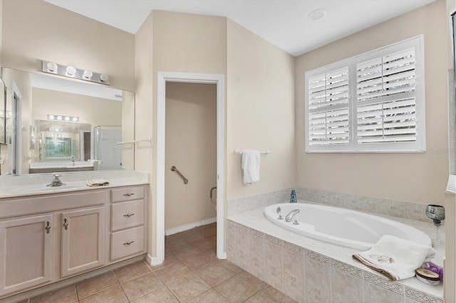 bathroom featuring tile patterned flooring, a shower stall, toilet, a garden tub, and vanity