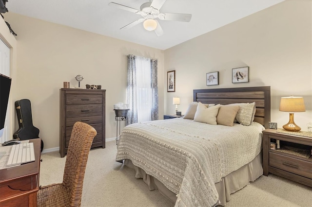 bedroom featuring baseboards, light colored carpet, and a ceiling fan