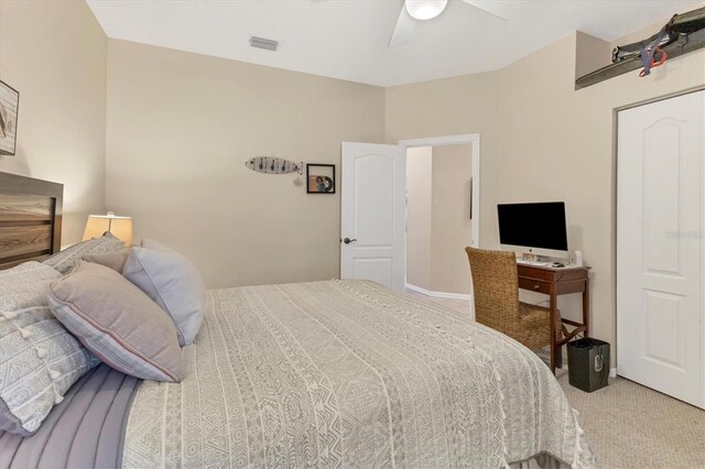 carpeted bedroom with visible vents and ceiling fan