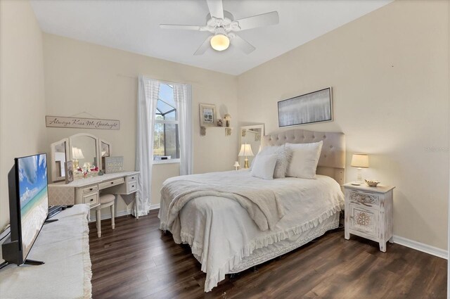 bedroom with ceiling fan, dark wood-type flooring, and baseboards