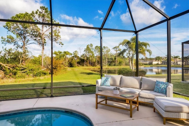 view of pool with a water view, a yard, glass enclosure, an outdoor hangout area, and a patio area