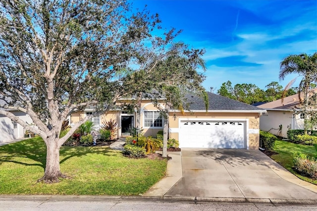 view of front of property featuring concrete driveway, a front yard, roof with shingles, stucco siding, and an attached garage