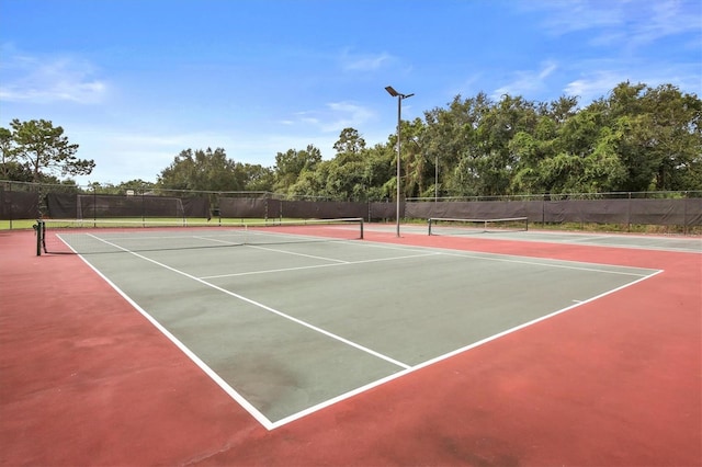 view of sport court featuring fence