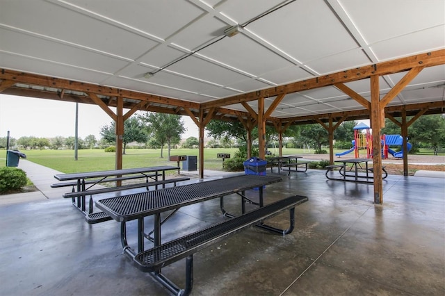 view of home's community featuring playground community and a lawn