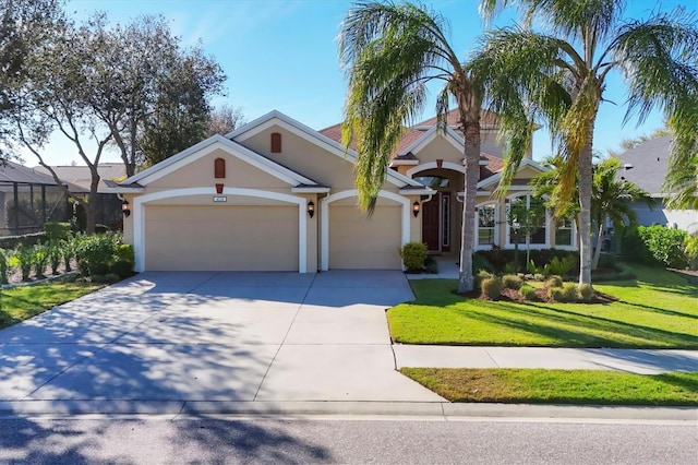 view of front of property with a garage, a front yard, concrete driveway, and stucco siding