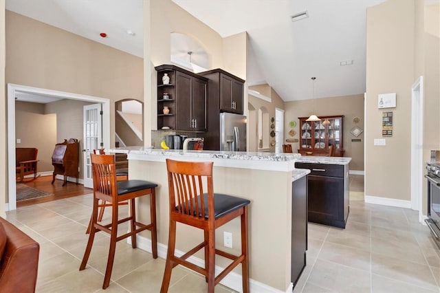 kitchen with open shelves, hanging light fixtures, dark brown cabinets, stainless steel refrigerator with ice dispenser, and light tile patterned flooring