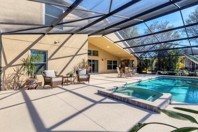 view of pool featuring a patio, a lanai, and a pool with connected hot tub