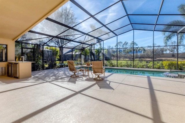 view of patio featuring outdoor dry bar, a lanai, and a pool with connected hot tub