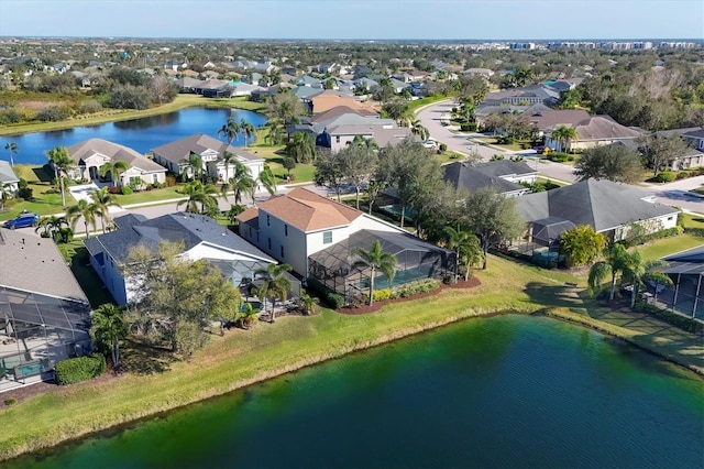 drone / aerial view with a water view and a residential view